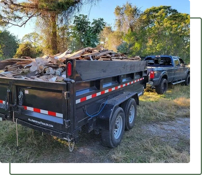 A dump truck and trailer with wood in the back.