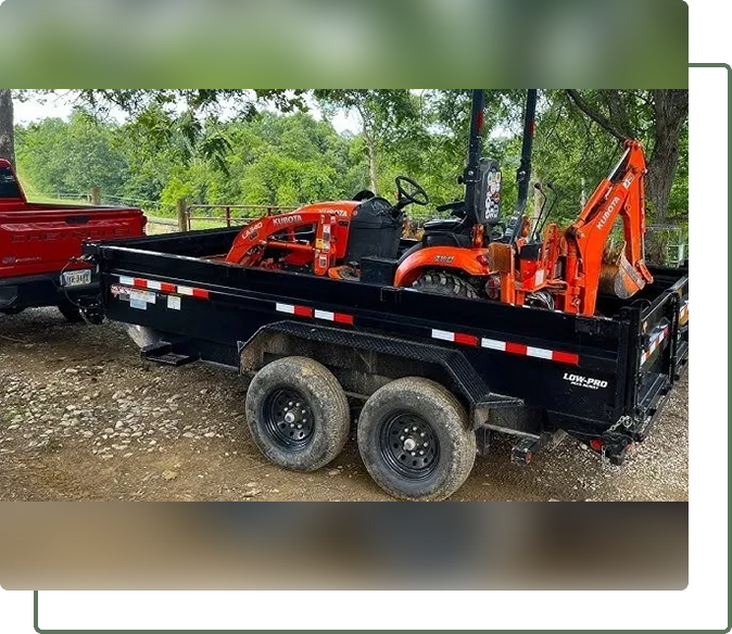 A dump trailer with a tractor on it.